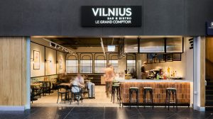 The new Vilnius Bar & Bistro Le Grand Comptoir at Vilnius Airport with tables and bar stools.