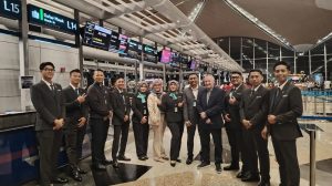 Representatives of Menzies Aviation and Kuala Lumpur airport pose for a photograph at the signing of the new contract for passenger services.