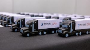 A row of toy Bradford Airport Logistics trucks.
